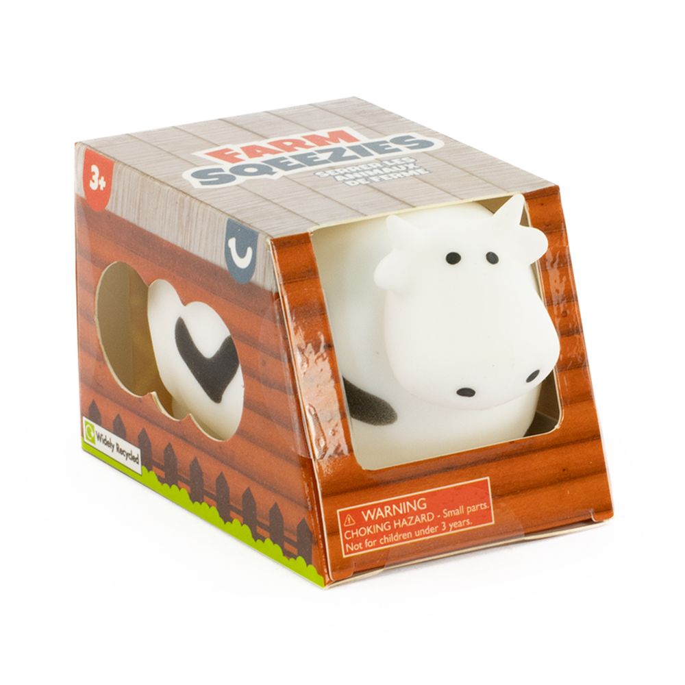 Farm Squeezies black and white cow squishy sensory toy in barn-themed box packaging, ages 3 plus