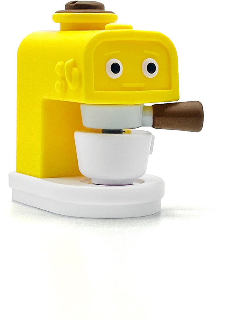 A small yellow and white coffee maker toy with cartoon eyes on the front and brown handle details, shown on a clean white background.