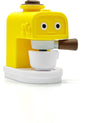 A small yellow and white coffee maker toy with cartoon eyes on the front and brown handle details, shown on a clean white background.