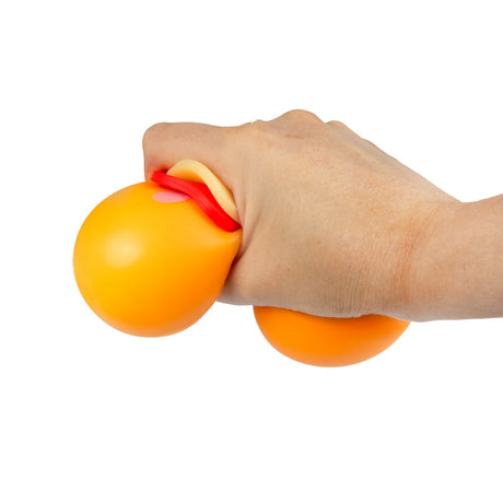 Orange fidget pizza base being squeezed in hand, soft squishy sensory stress toy