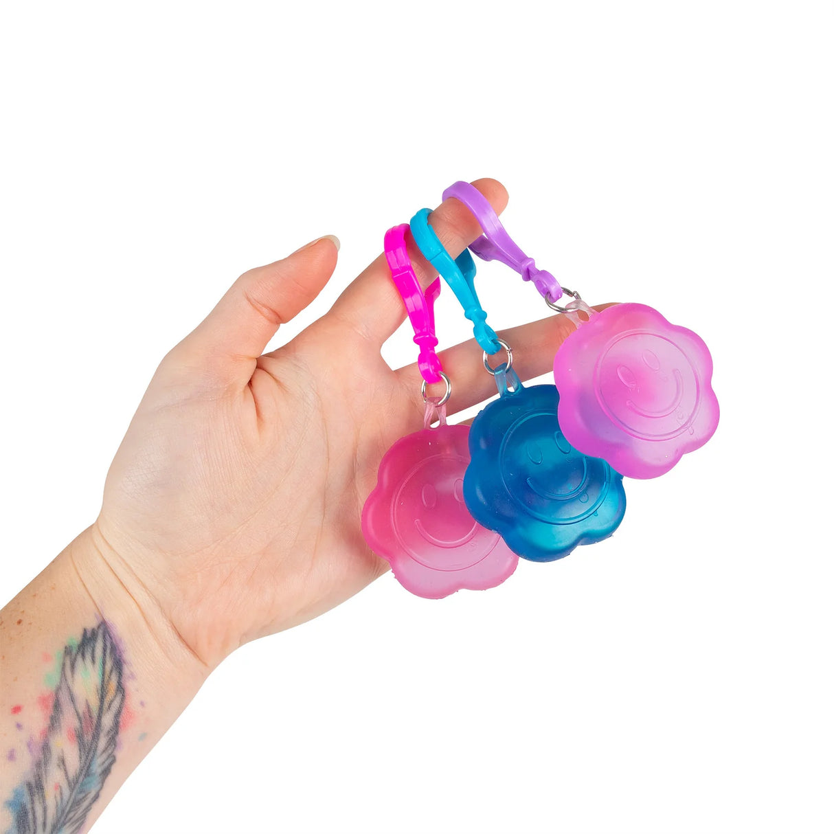 Three Scrunchems Flower Power squishy keyrings held in a hand showing size