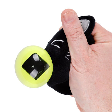 Hand squeezing Fortune Squeezies Lucky the Black Cat magic fortune teller plush squeezy toy with green magic ball showing no answer on fortune dice