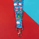 bright blue frog and clouds lanyard with silver clasp on red blue background