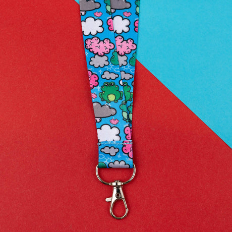 bright blue frog and clouds lanyard with silver clasp on red blue background