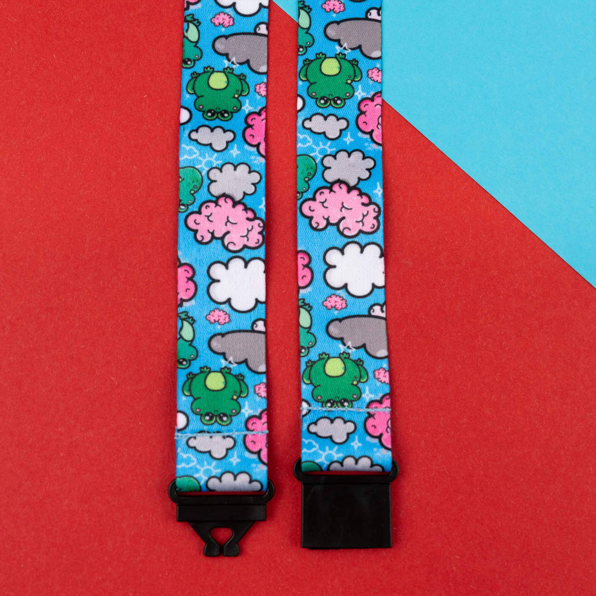 blue lanyard strap with green frogs and clouds pattern with black connectors