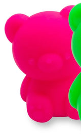Close-up texture detail of a neon pink fruity squish bear