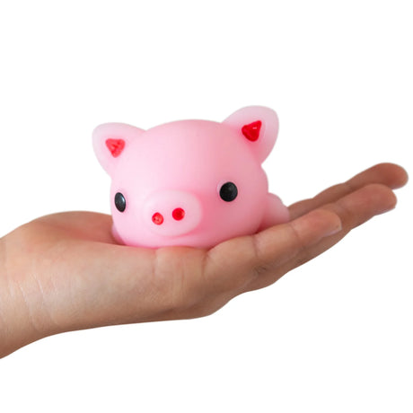 Pink pig giant squishy buddy resting in a hand to show size