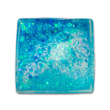 Blue teal glitter sugar cube from above showing aqua gel and chunky glitter pieces