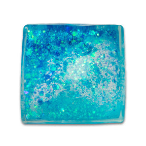 Blue teal glitter sugar cube from above showing aqua gel and chunky glitter pieces