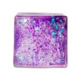Purple glitter sugar cube from above showing deep purple and teal iridescent glitter