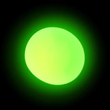Glow in the dark squish ball emitting a vivid green glow against a black background