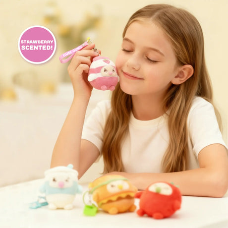 Child holding a pink strawberry milk Gum Gums keychain plush, a scented kawaii bag charm