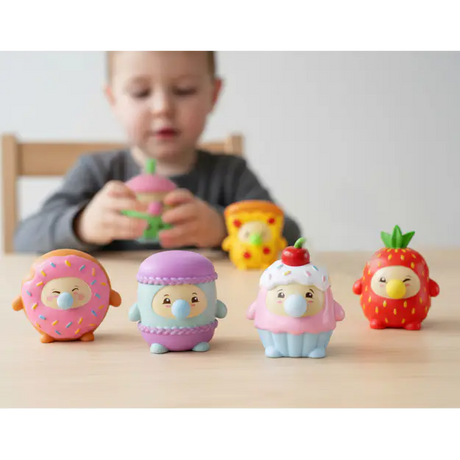 Donut, macaron, cupcake and strawberry Gum Gums squeeze toy figures lined up on table
