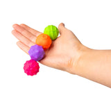HGL Magnetic Sensory Spheres neon fidget balls held in palm size reference