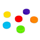 Six loose textured magnetic discs from the HGL Sensory Tower scattered on a white background
