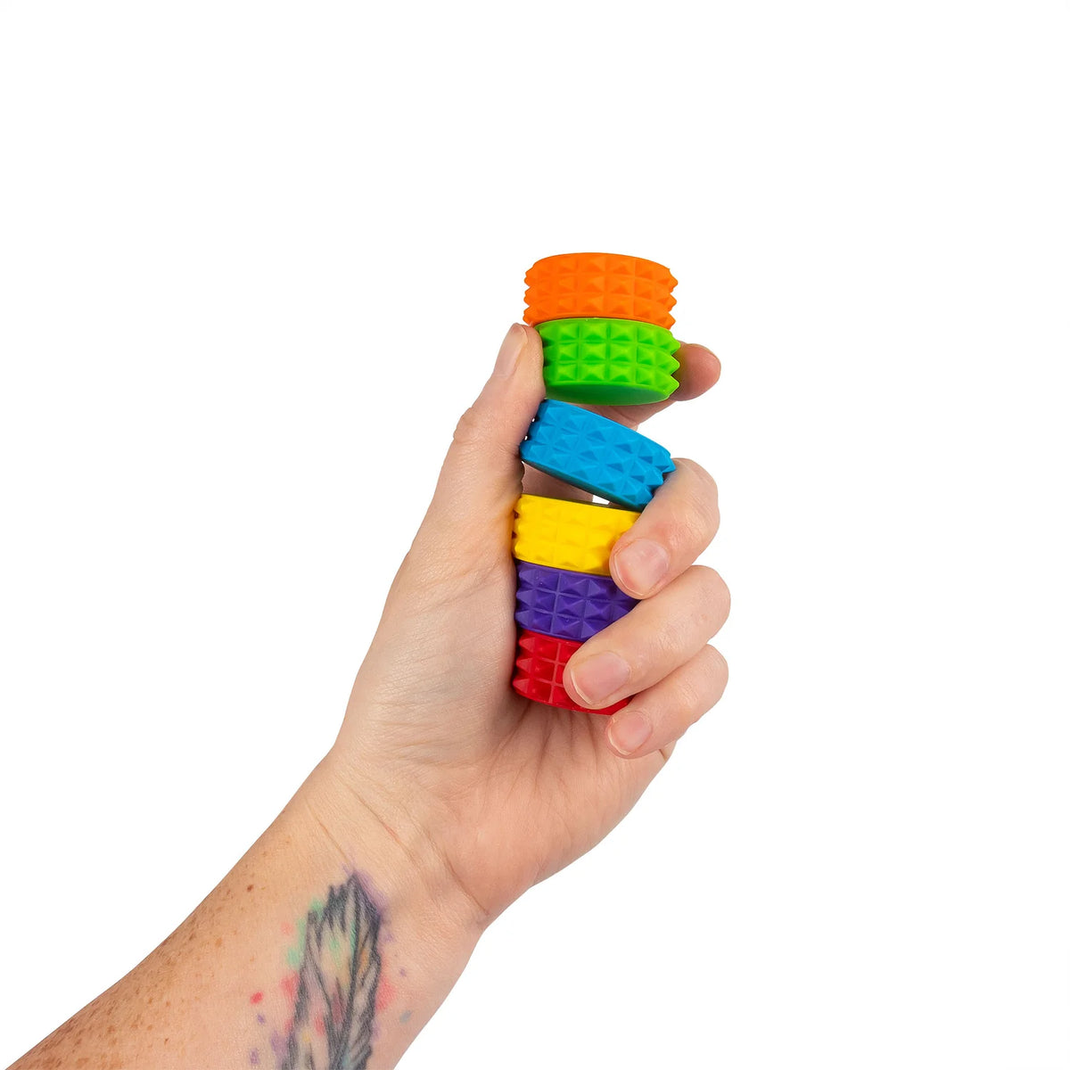 Hand holding a stacked tower of six textured magnetic discs from the HGL Sensory Tower