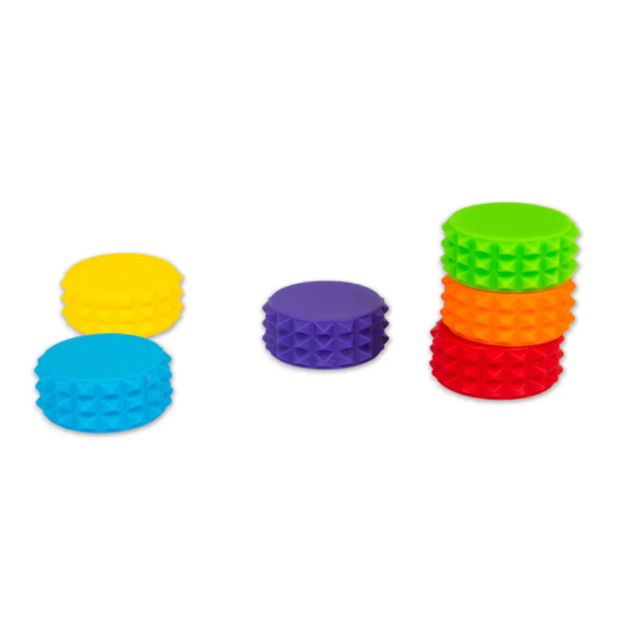 Six textured magnetic discs from the HGL Sensory Tower stacked in small groups in yellow, blue, purple, green, orange and red