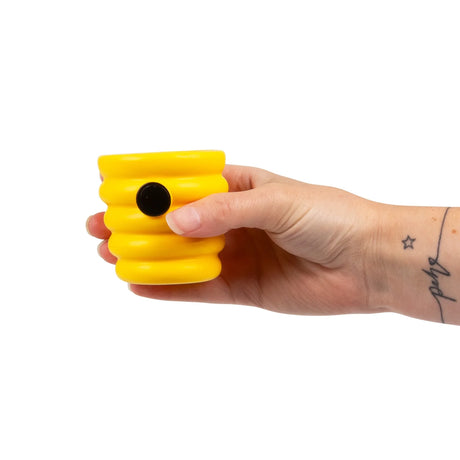 Yellow HGL Pop Up Beehive squeeze sensory fidget toy held in hand