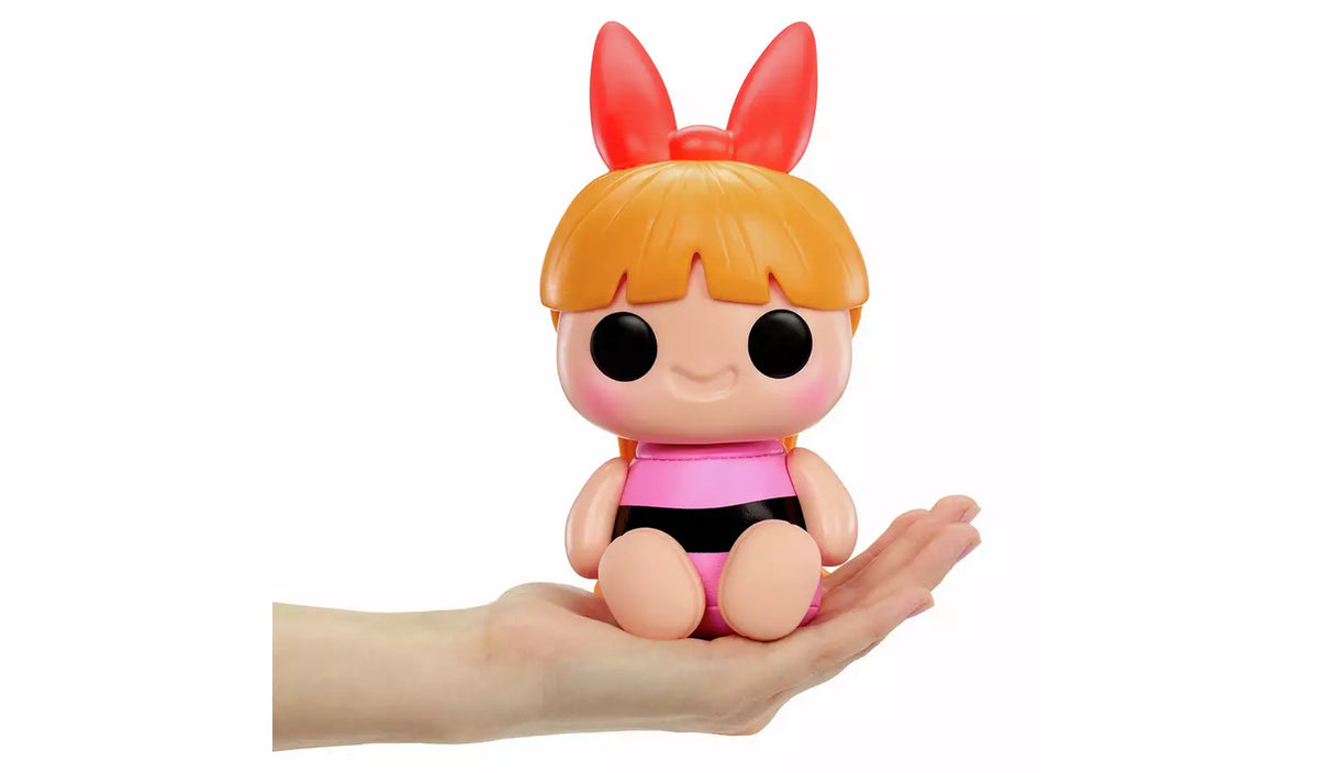 Hyojo Blossom squishy collectible in hand with orange hair, red bow and pink outfit