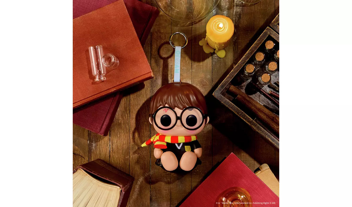 Hyojo Harry Potter squishy keychain figure with round glasses and striped scarf on wooden desk