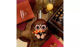 Hyojo Harry Potter squishy keychain figure with round glasses and striped scarf on wooden desk