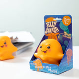 Orange kawaii jellyfish squishy stress toy next to its purple Jelly Squish gift box on a white desk