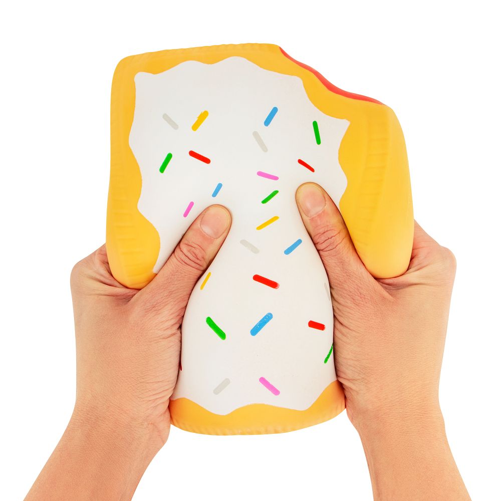 Two hands squeezing a jumbo golden yellow squishy Pop-Tart with white icing and rainbow sprinkles