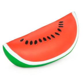 Jumbo slow-rise watermelon slice squishy toy, angled view showing red flesh, white rind and green skin with black seeds