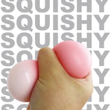 Hand squeezing pink kawaii bear squishy toy, stress relief sensory toy