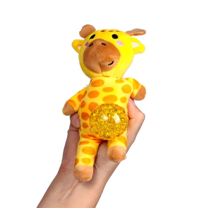 Kawaii giraffe gel bead belly squeeze plush toy being held in a hand with the yellow gel bead belly pushed out, showing the yellow spotted body and brown muzzle