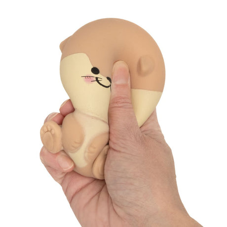 Brown otter kawaii squishy toy being squeezed, soft slow-rise sensory fidget toy