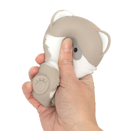 Grey raccoon kawaii squishy toy being squeezed, soft slow-rise sensory fidget toy