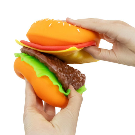 Two hands pulling apart the layers of a Keycraft Big Squij Peel 'N Stack Burger squishy toy