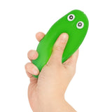 Hand squeezing a bright green Keycraft Crunchy Pickle squishy fidget toy with cartoon eyes
