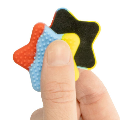 Keycraft star-shaped fidget magnet sensory toy, red blue yellow, held between fingers