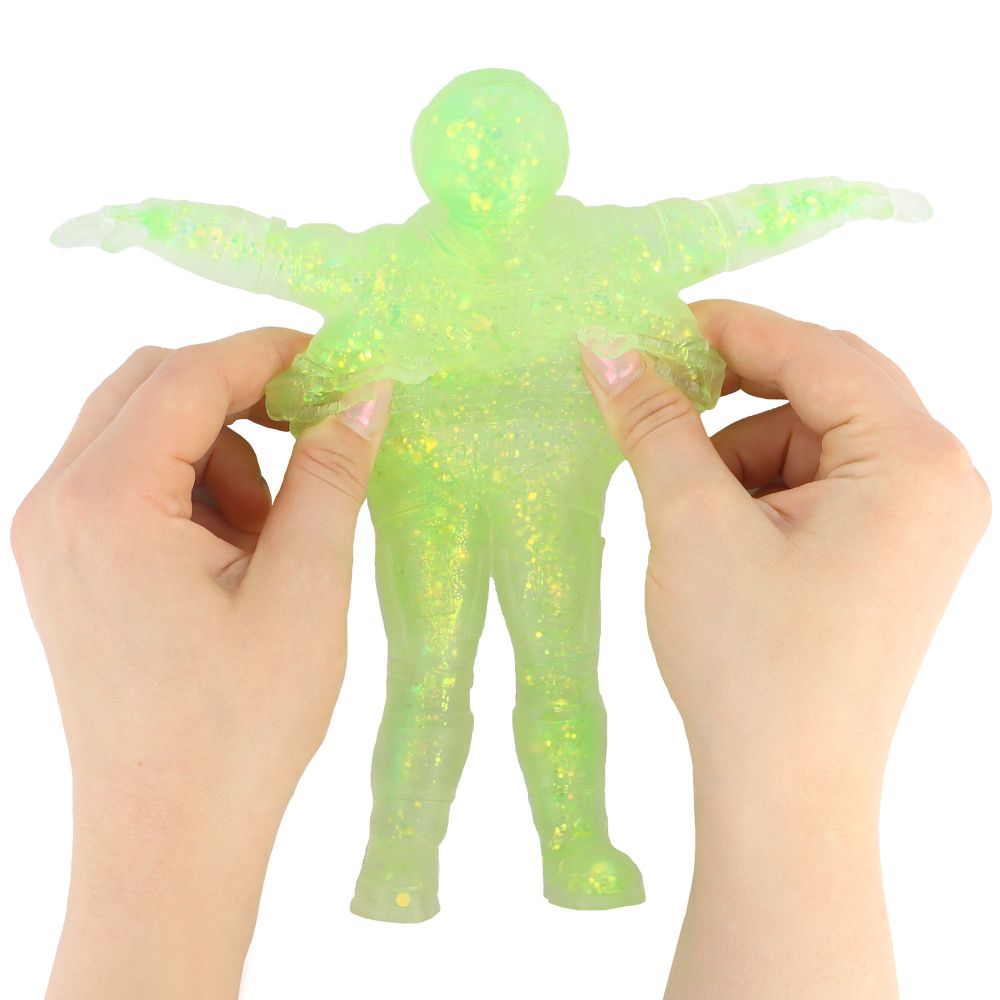 Hands squeezing glittery green translucent stretchy spaceman fidget toy with arms spread wide