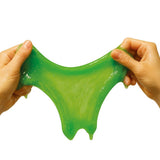 Green slime being stretched between two hands on a white background
