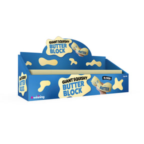 A blue and yellow display box for 'Giant Squishy Butter Block' by Winning, featuring cartoon butter-splatter graphics and a small illustration of a hand squeezing a giant butter block.