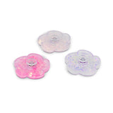 Three flower fidget spinners in pink, white, and lilac with liquid glitter