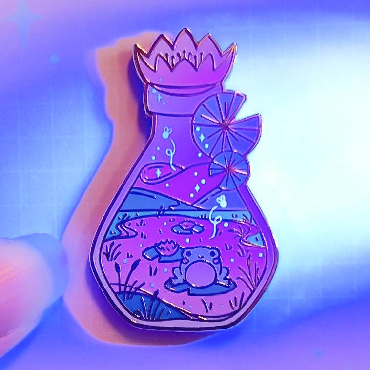 Lula Rocks Bottled Frog UV Glow enamel pin, purple glow colorway