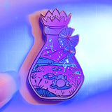 Lula Rocks Bottled Frog UV Glow enamel pin, purple glow colorway