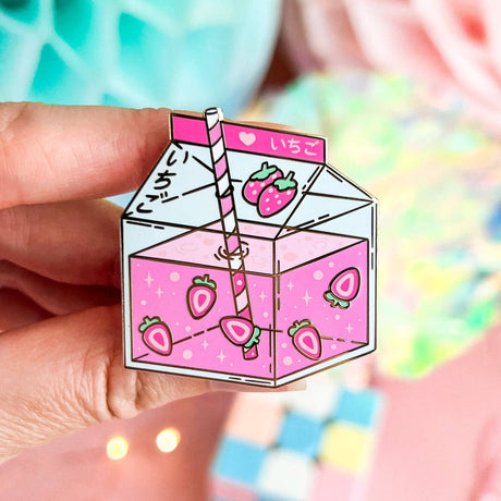 Lula Rocks Strawberry Milk kawaii enamel pin, pink ichigo carton, hand-held close-up
