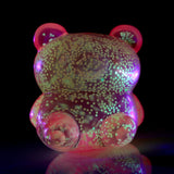 Pink Marshmallow Bears squeeze toy glowing green in the dark showing glow effect