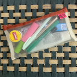 transparent mesh pencil pouch with brown zip holding pens highlighters and carmex
