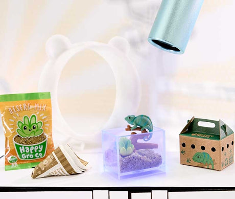 MGA Miniverse Make It Mini Animals completed chameleon terrarium scene displayed under UV light with desert accessories