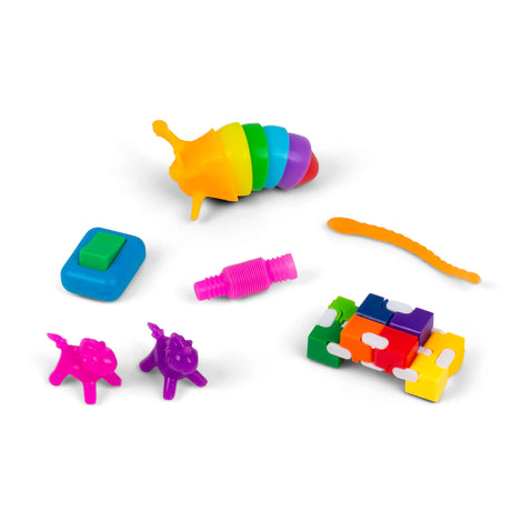 Flatlay of all Micro Fidgetz Series 2 items including fidget slug, clicker, pop tube, worm, unicorns and infinity cube