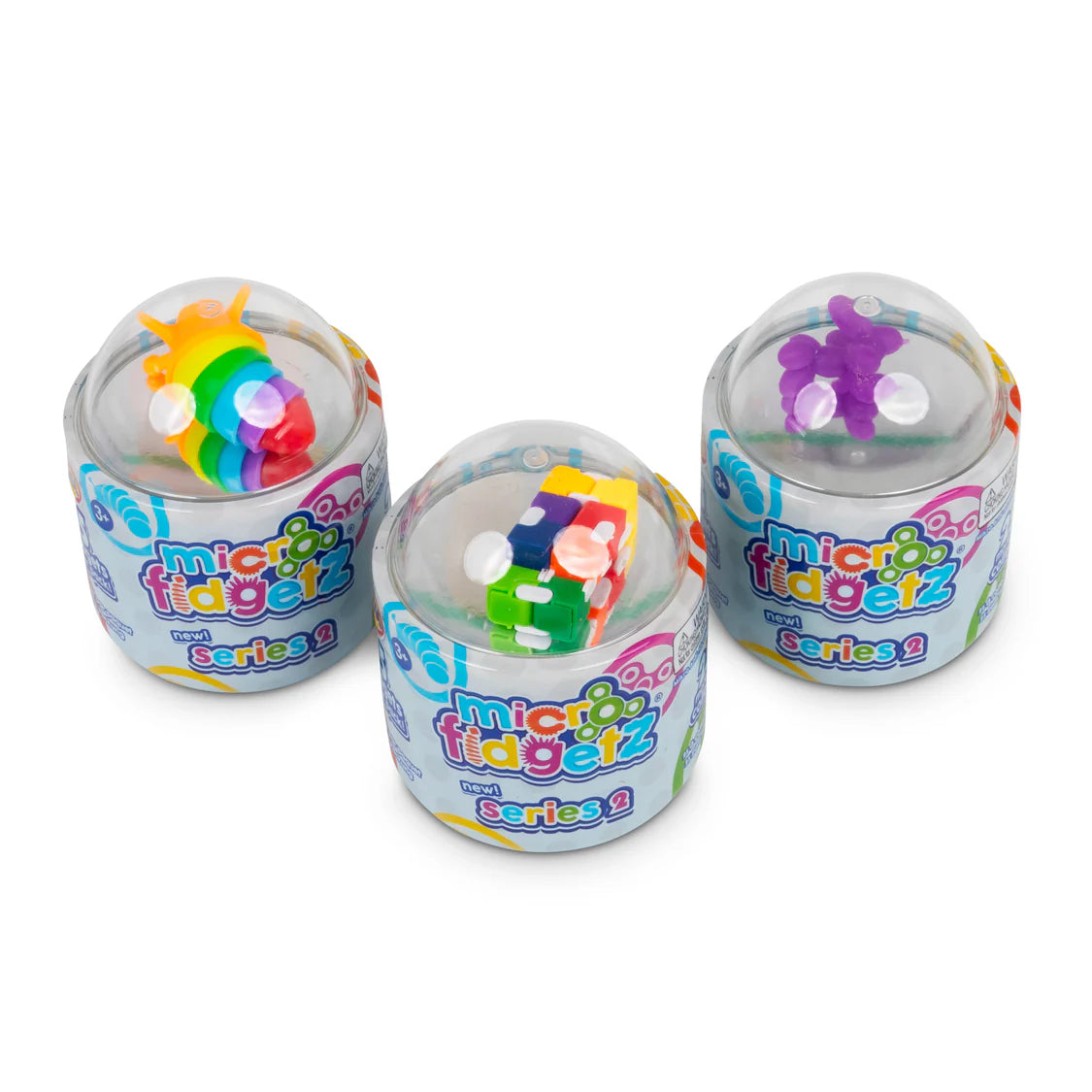Three Micro Fidgetz Series 2 tubs at an angle showing different visible fidgets through the clear dome lids