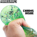 Green Minecraft Jelly SquishMe cube squeezed, glitter charms inside, sensory fidget toy