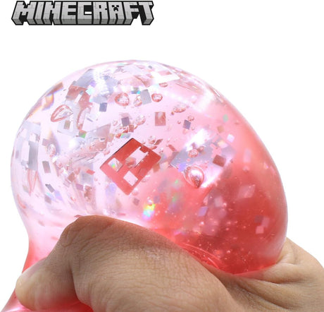 Red Minecraft Jelly SquishMe cube being squeezed, glitter squishy sensory fidget toy