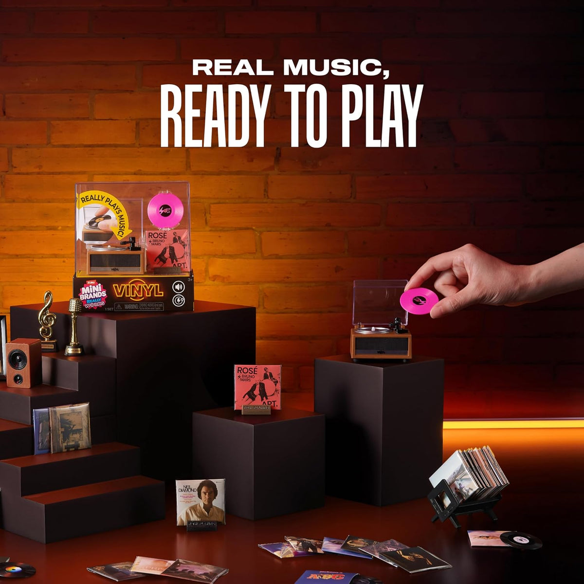 Hand placing pink mini vinyl on Mini Brands Really Works working miniature record player